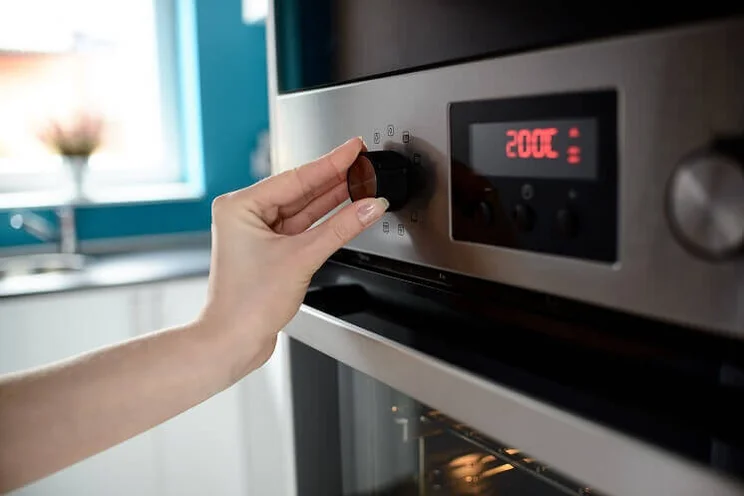 Oven being set to 200 degrees Celsius