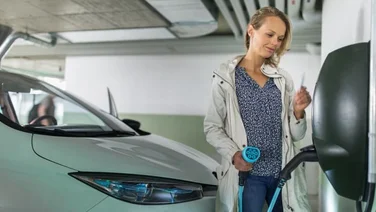 woman charges her electric vehicle