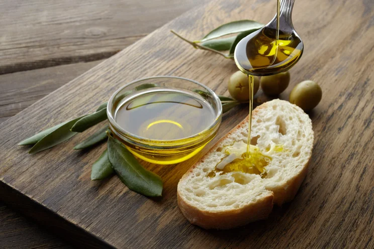 Olive oil being drizzled on bread