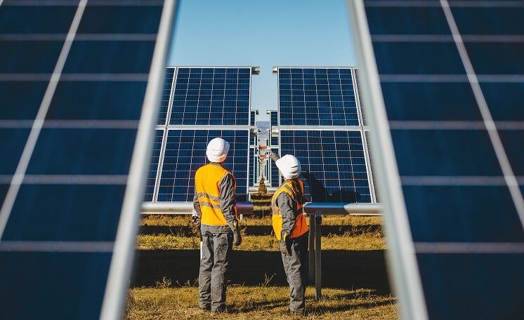 Two workers on solar farm