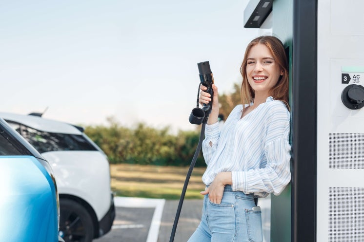woman holding electric car charger