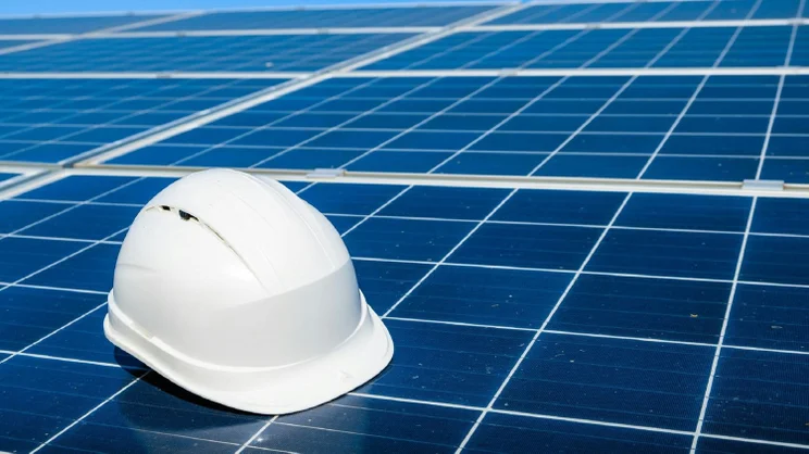 A hard hat on a solar panel