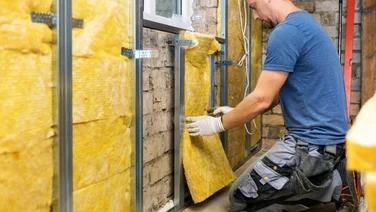 man installing solid wall insulation