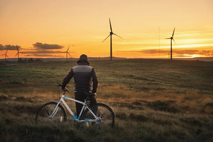 Man in front of wind farm
