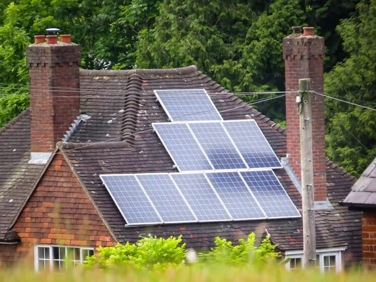 rural red brick house with solar panels on roof