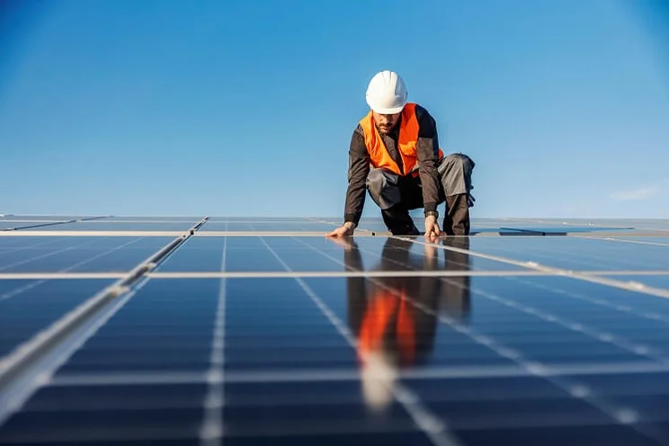 Solar panels being installed with sky in background