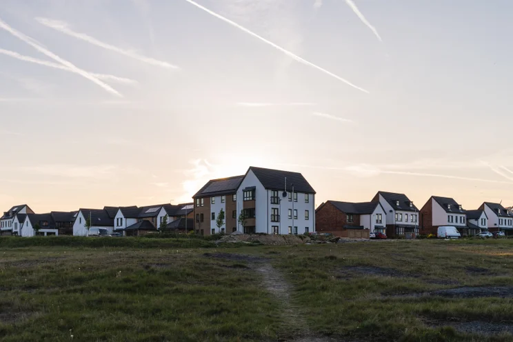 A row of houses across a field