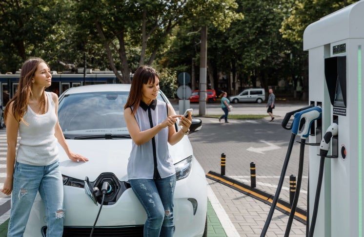 women with an electric car