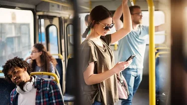 Lady on bus looking at phone