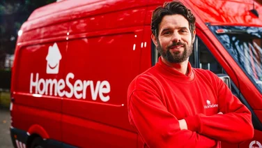 homeserve engineer in front of a homeserve van