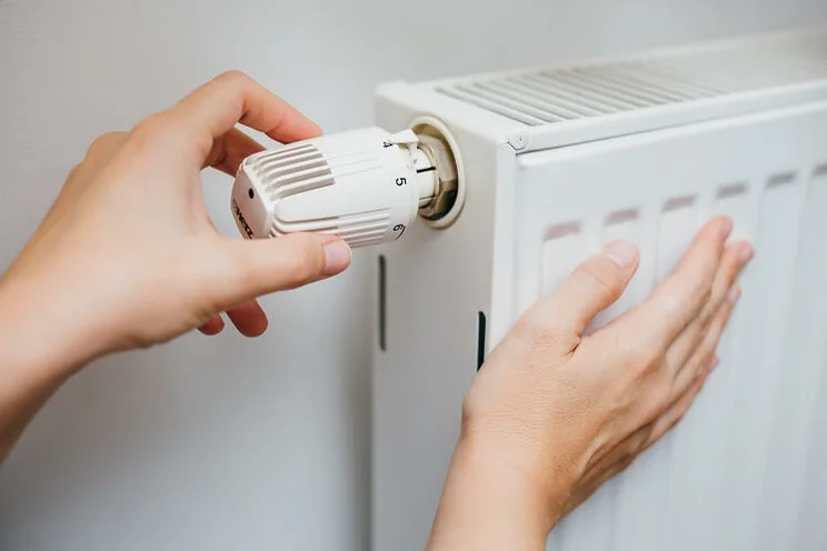 someone touching a radiator