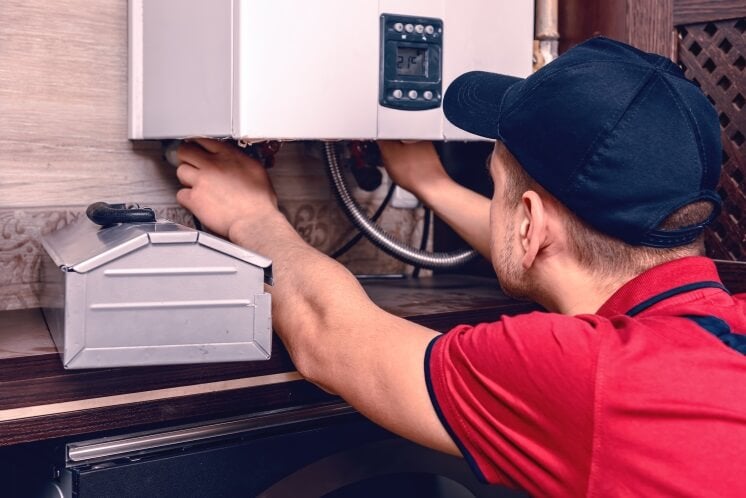 a man installs a combi boiler