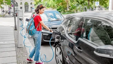 woman charging electric vehicle