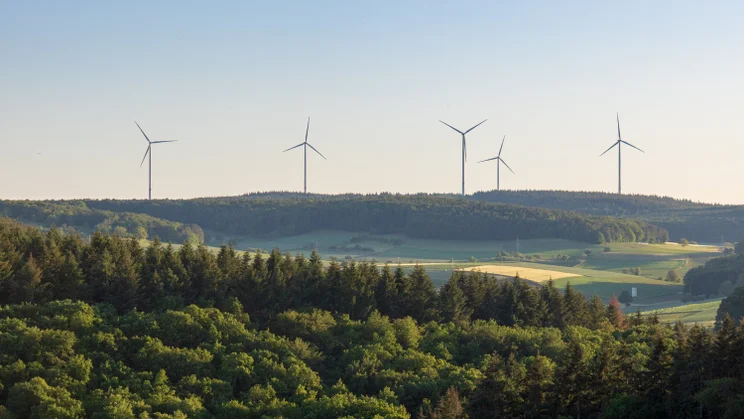 A wind farm on top of a hill