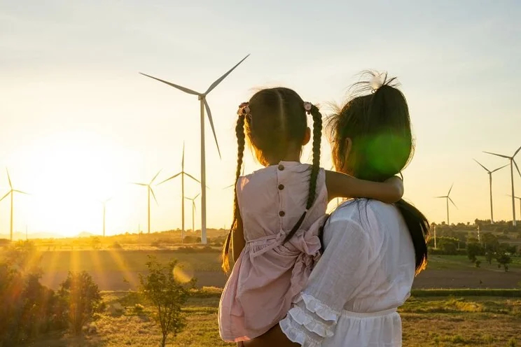 family look at wind turbines