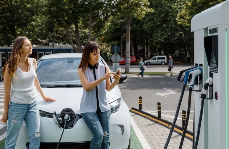 women with an electric car