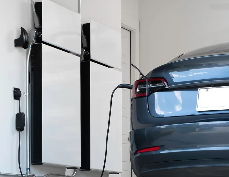 Electric car being charged by home storage battery