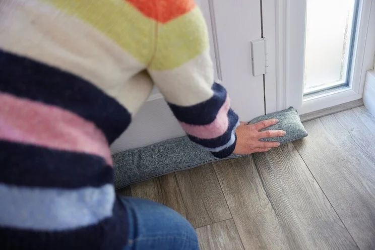 Blocking a draughty door with draught blocker