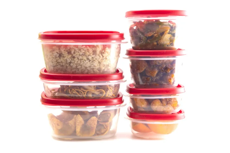 Boxes with red lids filled with leftover food