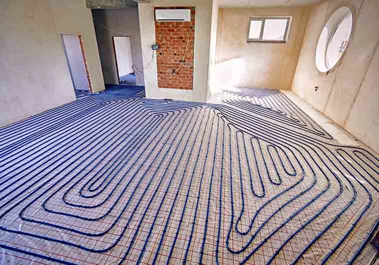 Piping used for underfloor heating is laid out across the floor