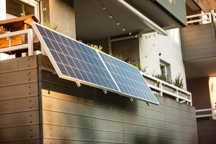 solar panels suspended from a balcony with wooden barrier