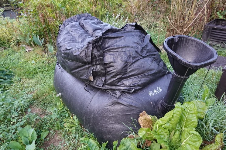 A biodigester producing biogas in a garden