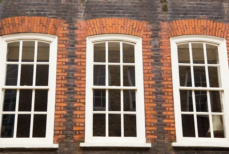 Three sash windows on an old property in England