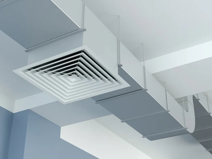 close up of white ventilation pipes inside a building