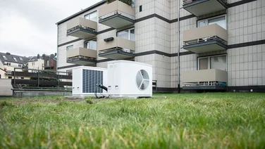 ground source heat pumps installed on lawn outside a block of flats
