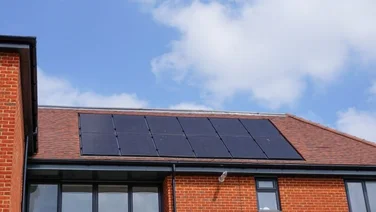 house with visible bricks and solar panels on the roof