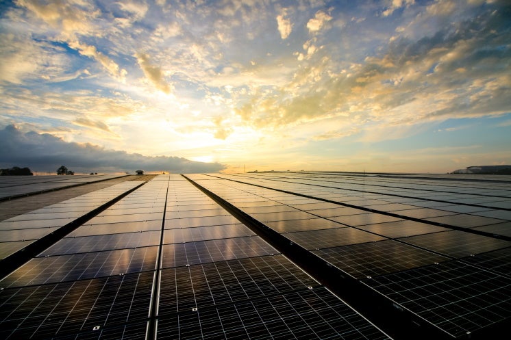 the sun shines on solar panels