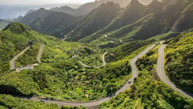 green mountain scenery with roads passing through it