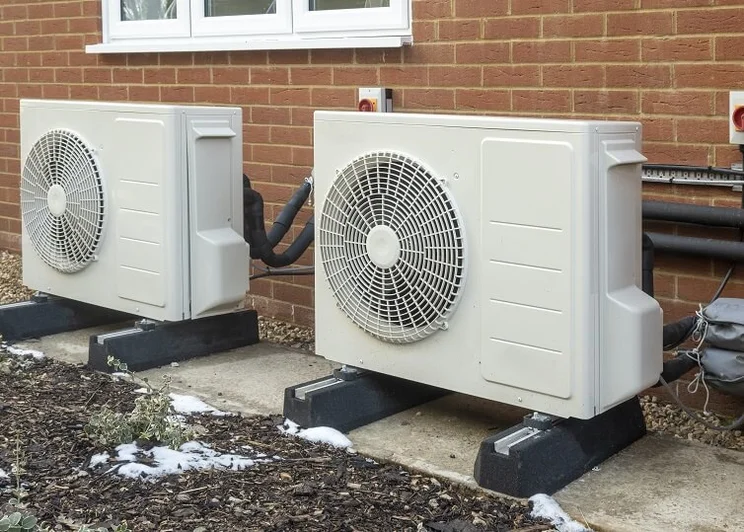 Two air source heat pumps outside a property.