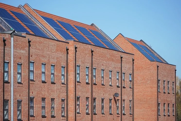 Solar panels on roof of apartment building in UK