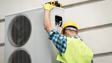 Specialist doing heat pump maintenance