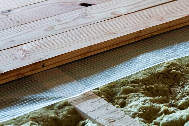planks of floorboards with insulating material in between them