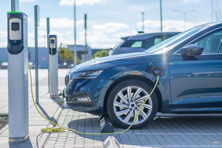 Electric car plugged in to an EV charger at a car park