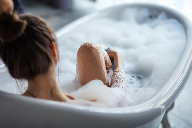 woman taking bubble bath in a tub