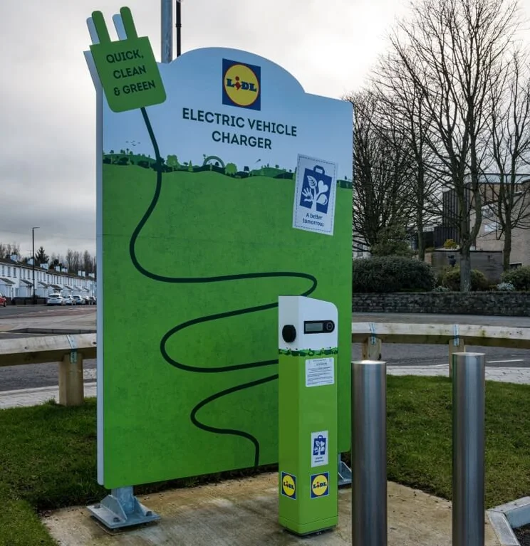 a lidl charging station with a green information board