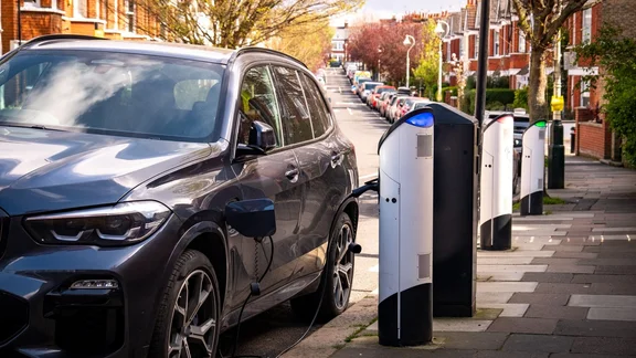 An EV being charged on a residential street