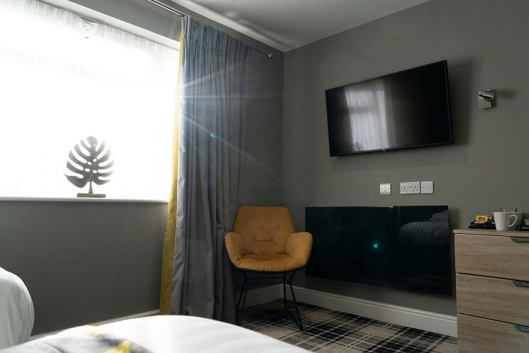 Infrared heating panel mounted on bedroom wall