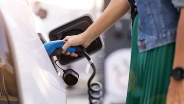 woman charging her electric vehicle