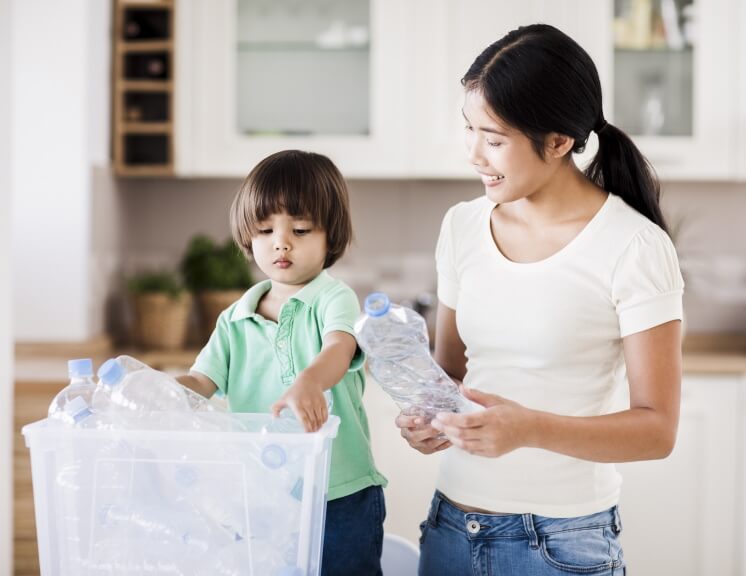 woman and boy recycling plastic