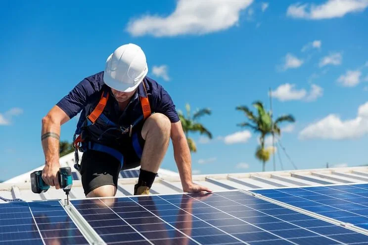 Solar panel installer on a sunny day