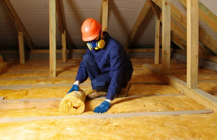 tradesperson insulating a loft