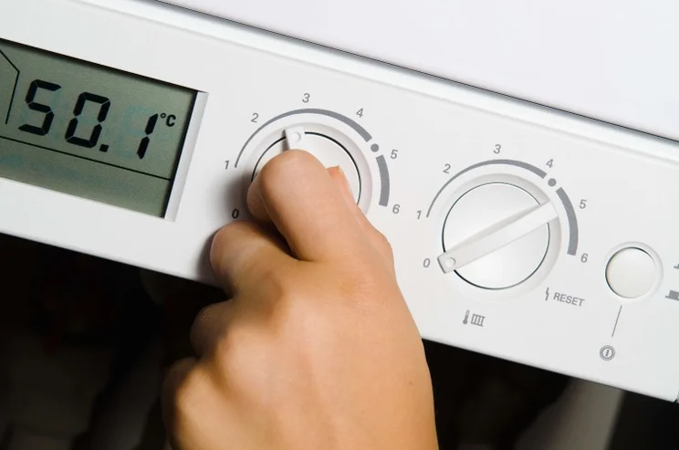 a person changes the temperature on their oil boiler, which costs more than most types of boiler
